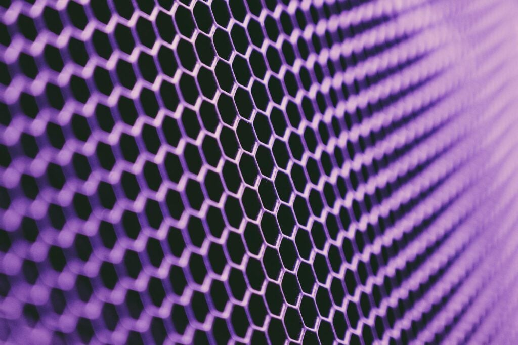 abstract geometric texture of purple metallic net on dark background