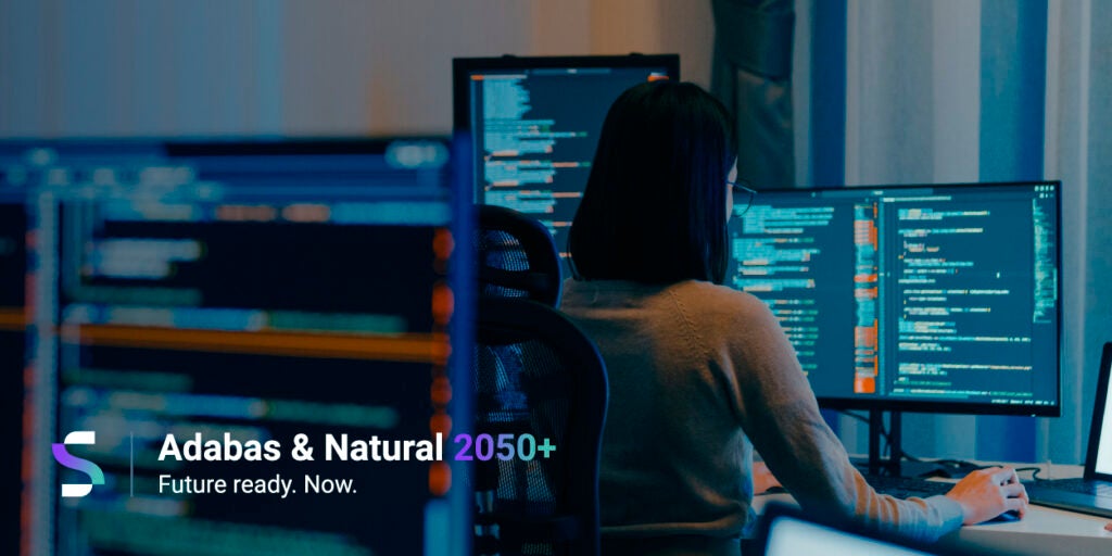 woman coding in a dark room
